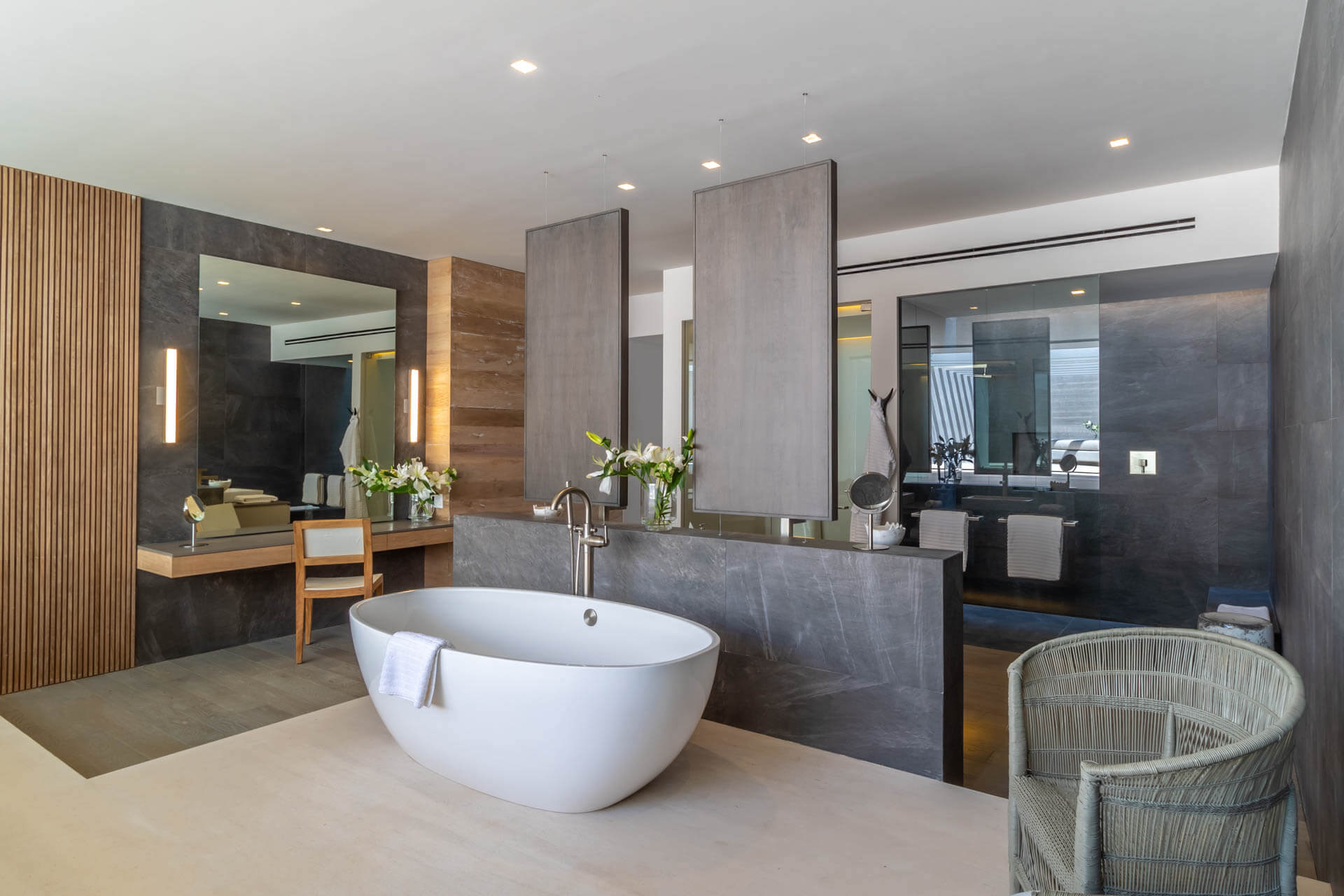 Primary ensuite with freestanding soaking tub, dark slate walls, twin mirrors, and dressing table, Estate Afrique, Ranchos Estates, Punta Mita.