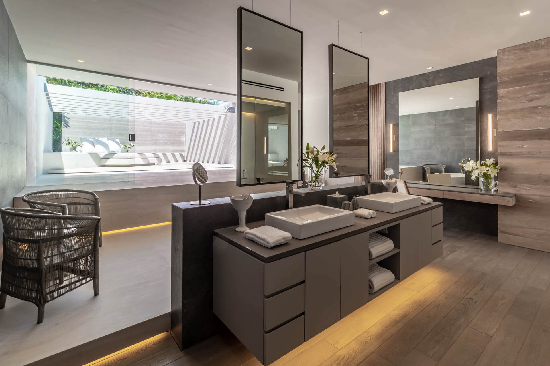 Primary ensuite double vanity with LED kick-lighting, tall mirrors, and floor-to-ceiling window onto pool, Estate Afrique, Ranchos Estates, Punta Mita.
