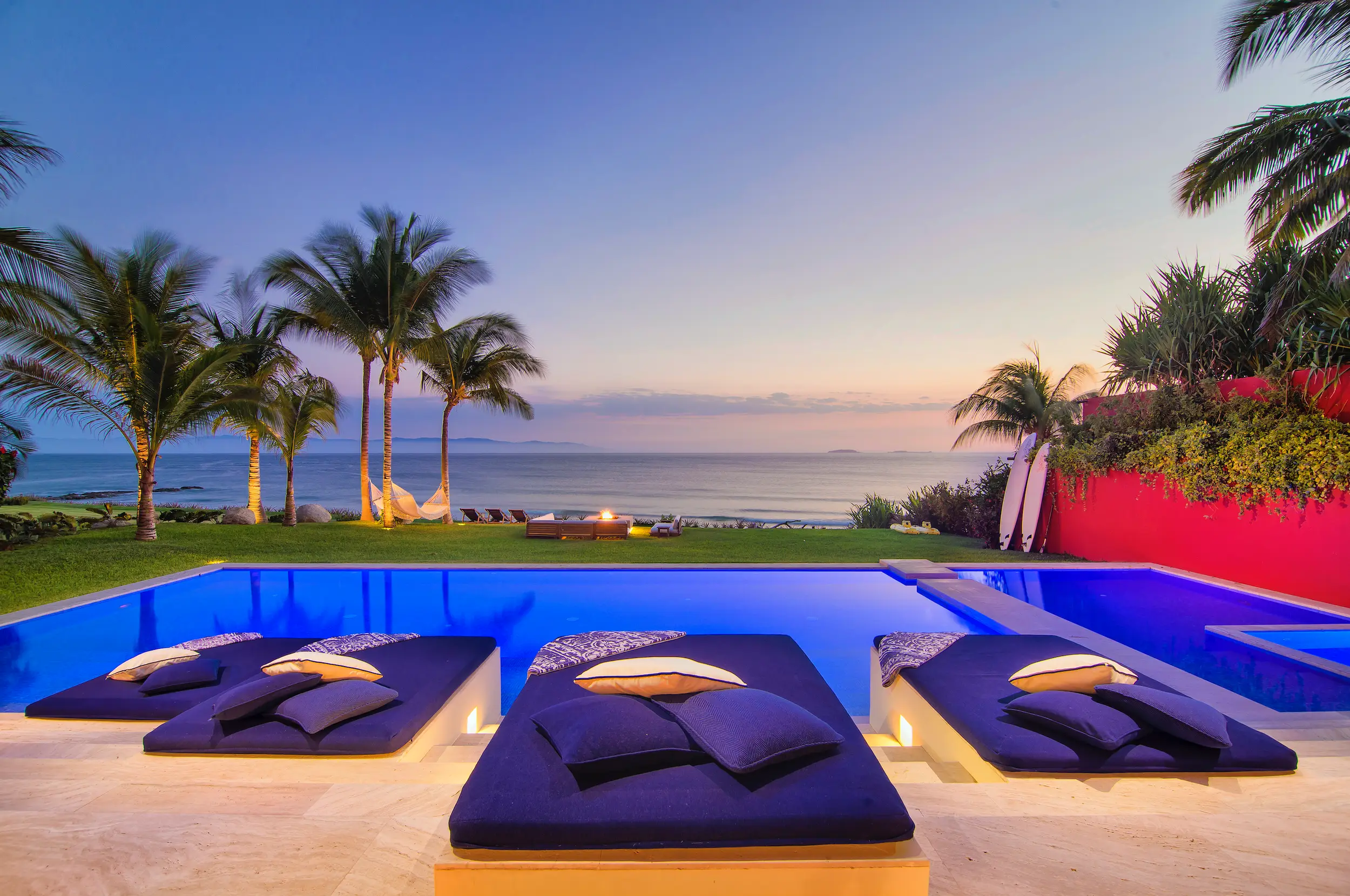 Pool daybeds at dusk with palms and Pacific horizon beyond, Villa Pacífica, Ranchos Estates, Punta Mita.