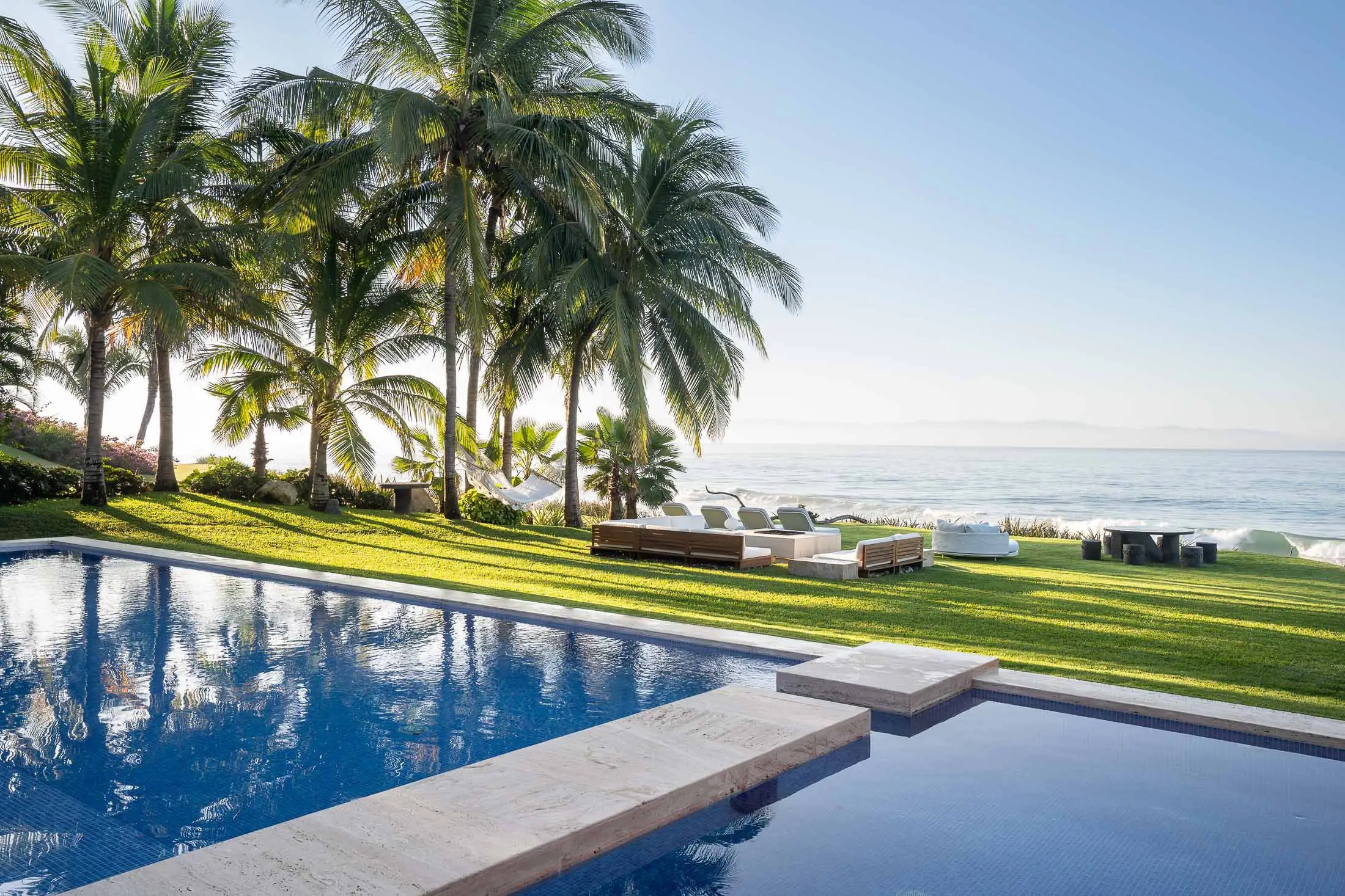 Pool terrace with manicured lawn, coconut palms, and chaise lounges facing the Pacific, Villa Pacífica, Ranchos Estates, Punta Mita.