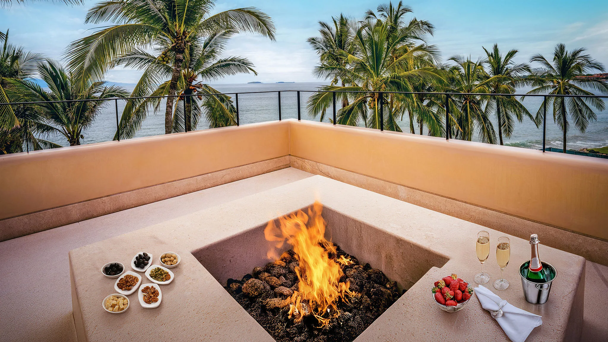 Modern fire pit on Casa Happy Paws terrace, Ranchos Estates, Punta Mita; ocean views, palm trees, snacks and champagne.