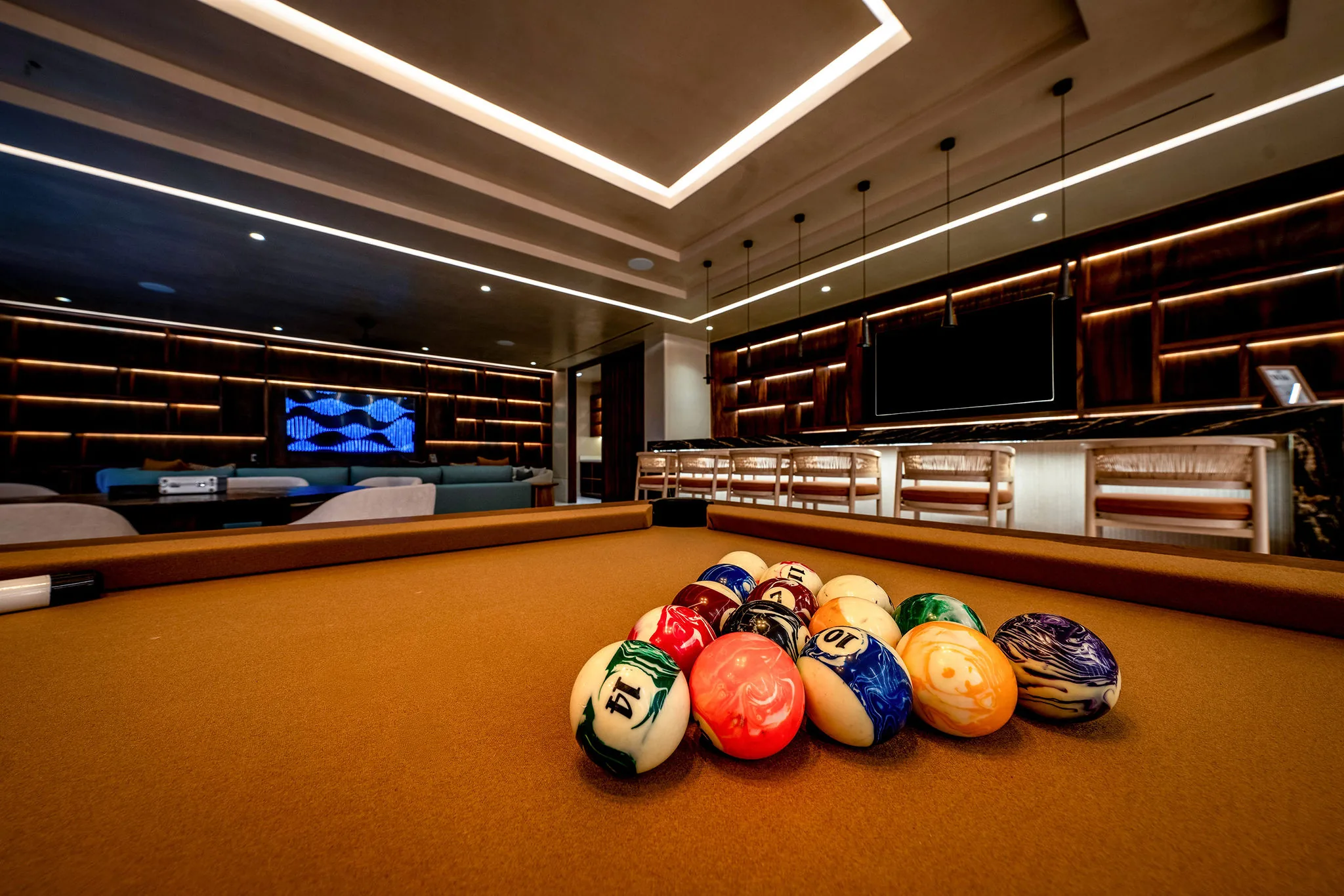 Modern game room at Casa Happy Paws, Punta Mita, with pool table, TV, bar seating, and stylish lighting in Ranchos Estates.