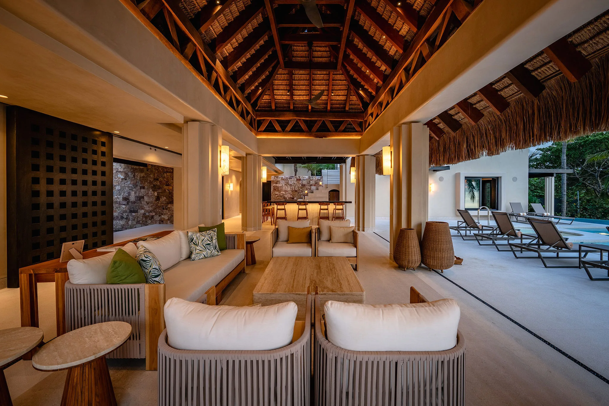 Casa Happy Paws, Punta Mita: open-air luxury living room with wood decor, vaulted thatched ceiling, poolside lounge.