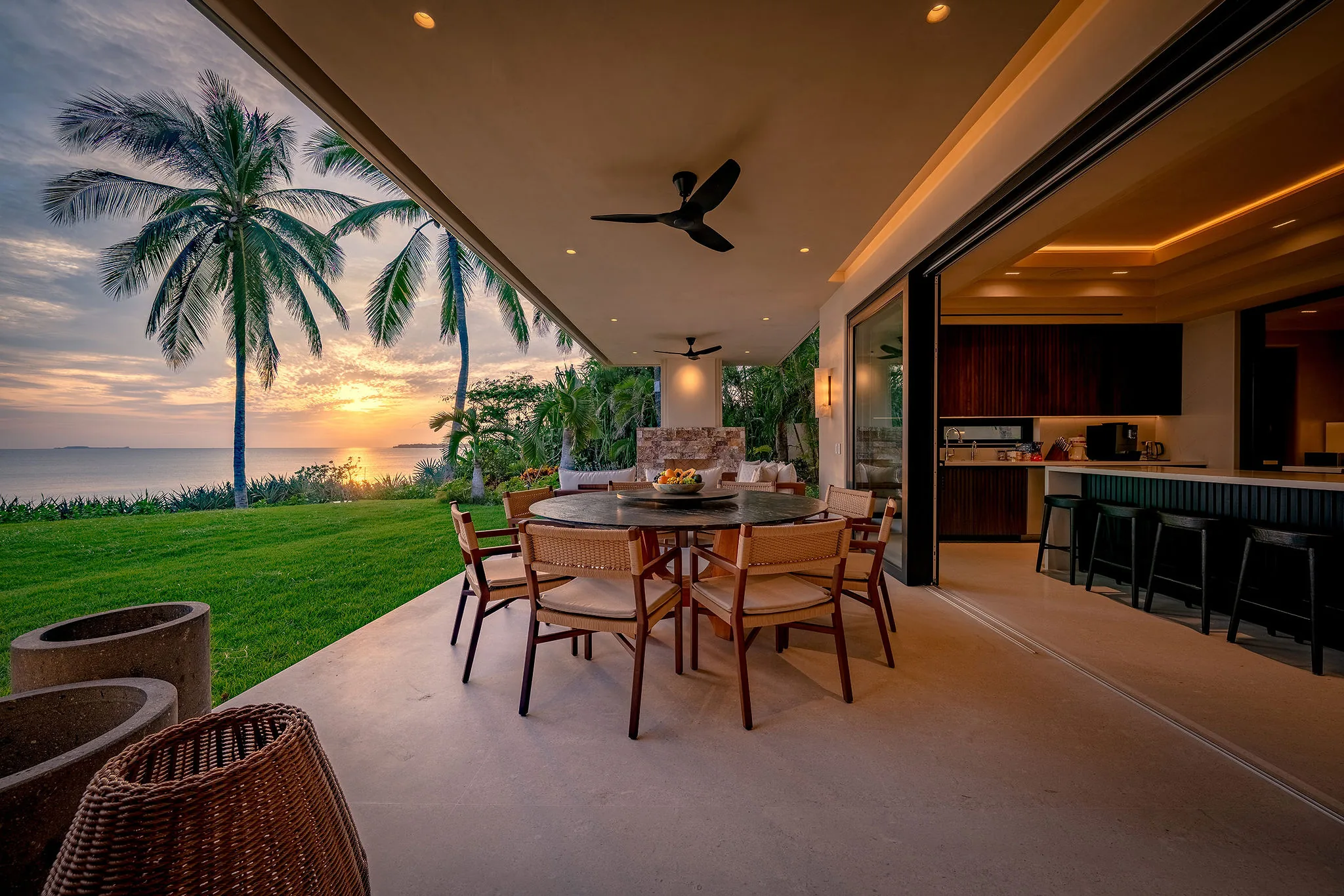 Chic Casa Happy Paws patio in Ranchos Estates, Punta Mita with ocean sunset views and seamless open kitchen access.