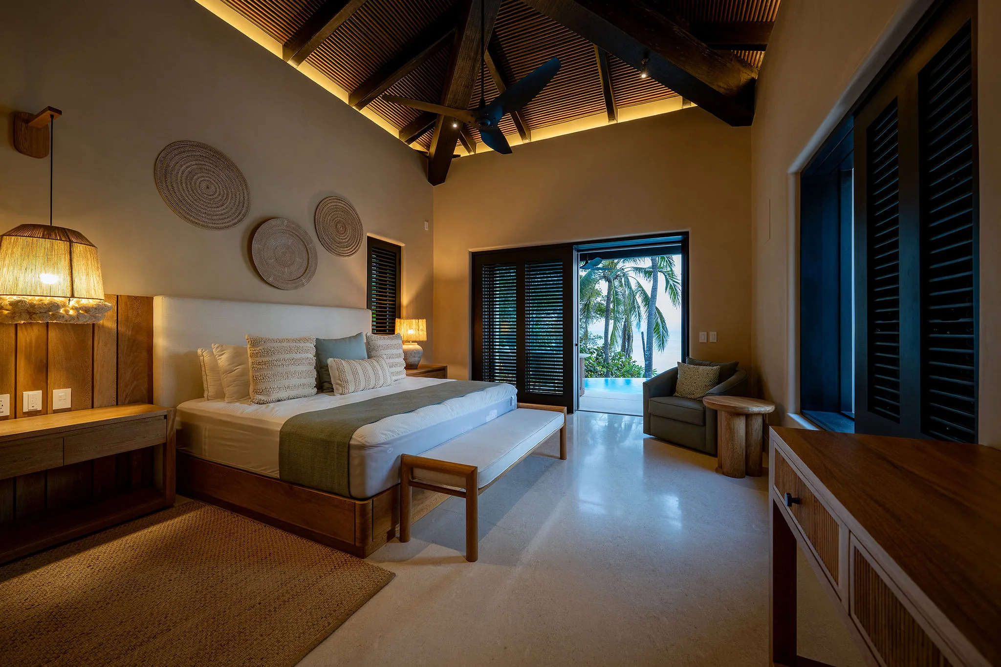 Chic bedroom at Casa Happy Paws, Ranchos Estates, Punta Mita; modern décor, palm views, wood accents, airy vibe.